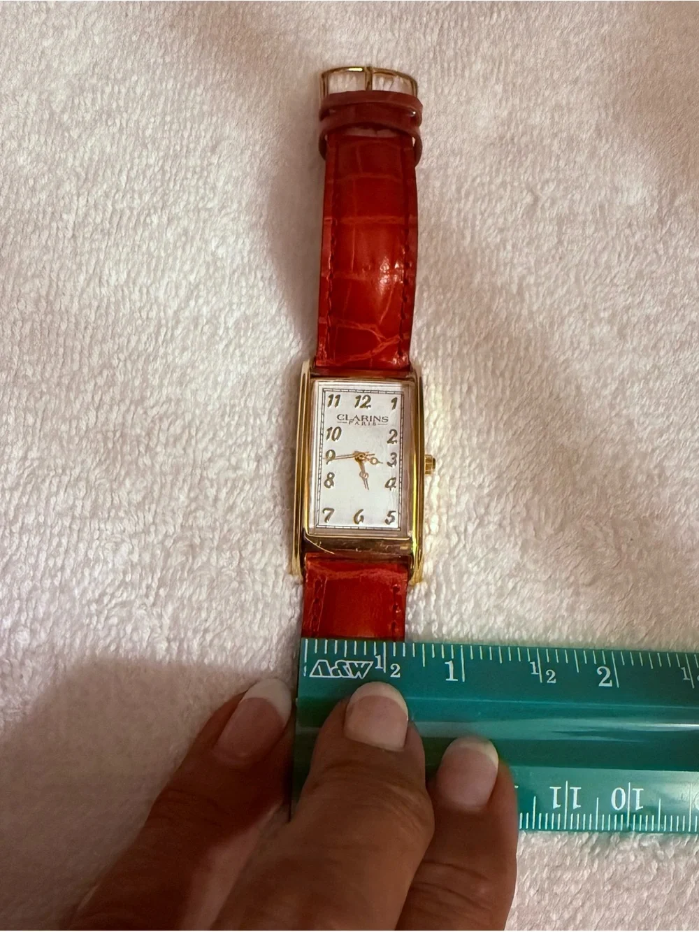 Clarins Gold-Tone Rectangular Watch with Red Strap and White Dial